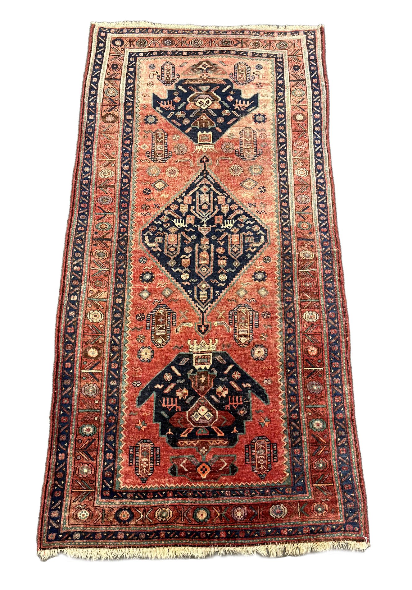 An Heriz red ground medallion rug 280 x 137cm